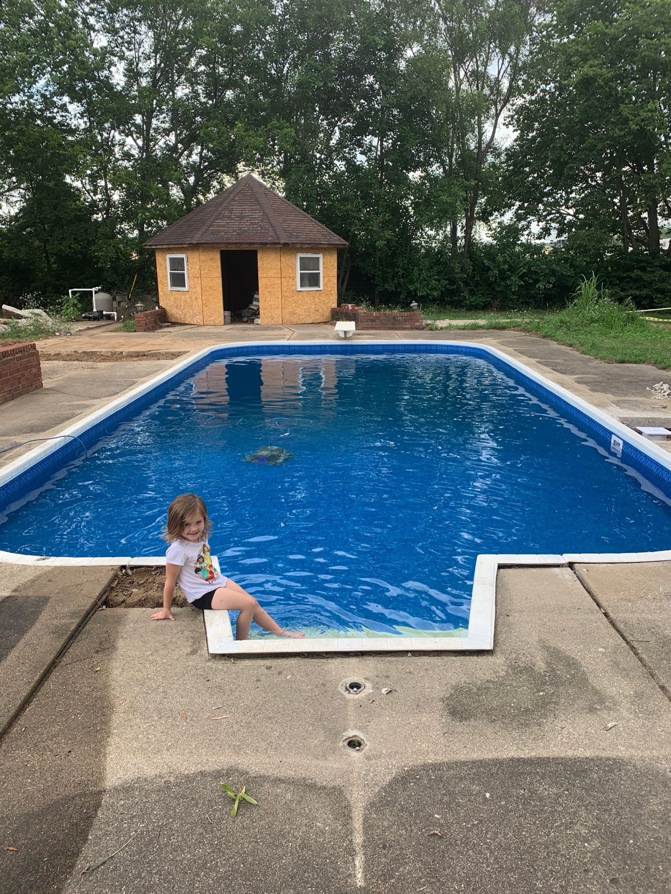 Pool-house pool filled with bright blue water after its liner replacement