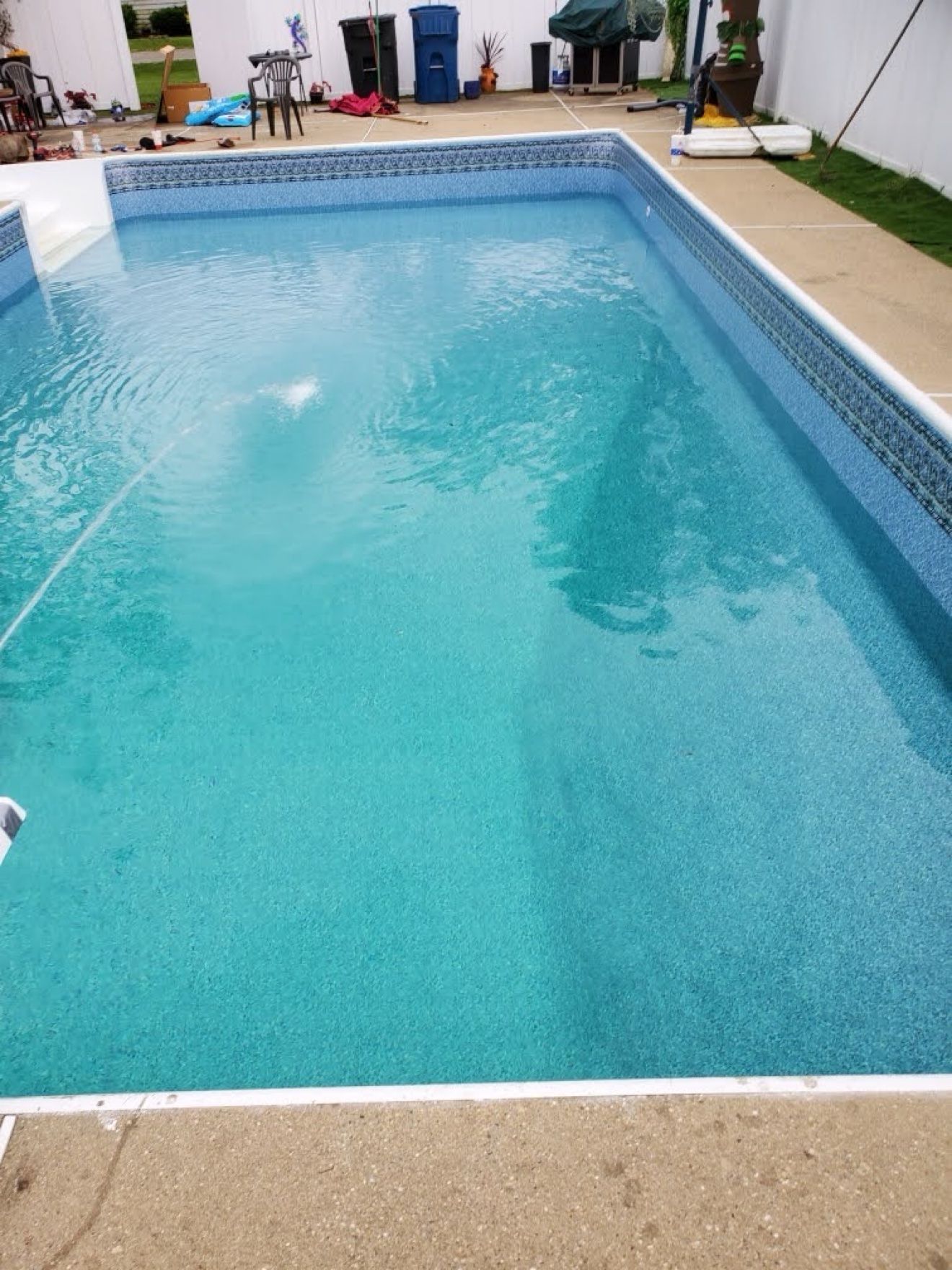 Same pool filled with bright turquoise water after its liner replacement