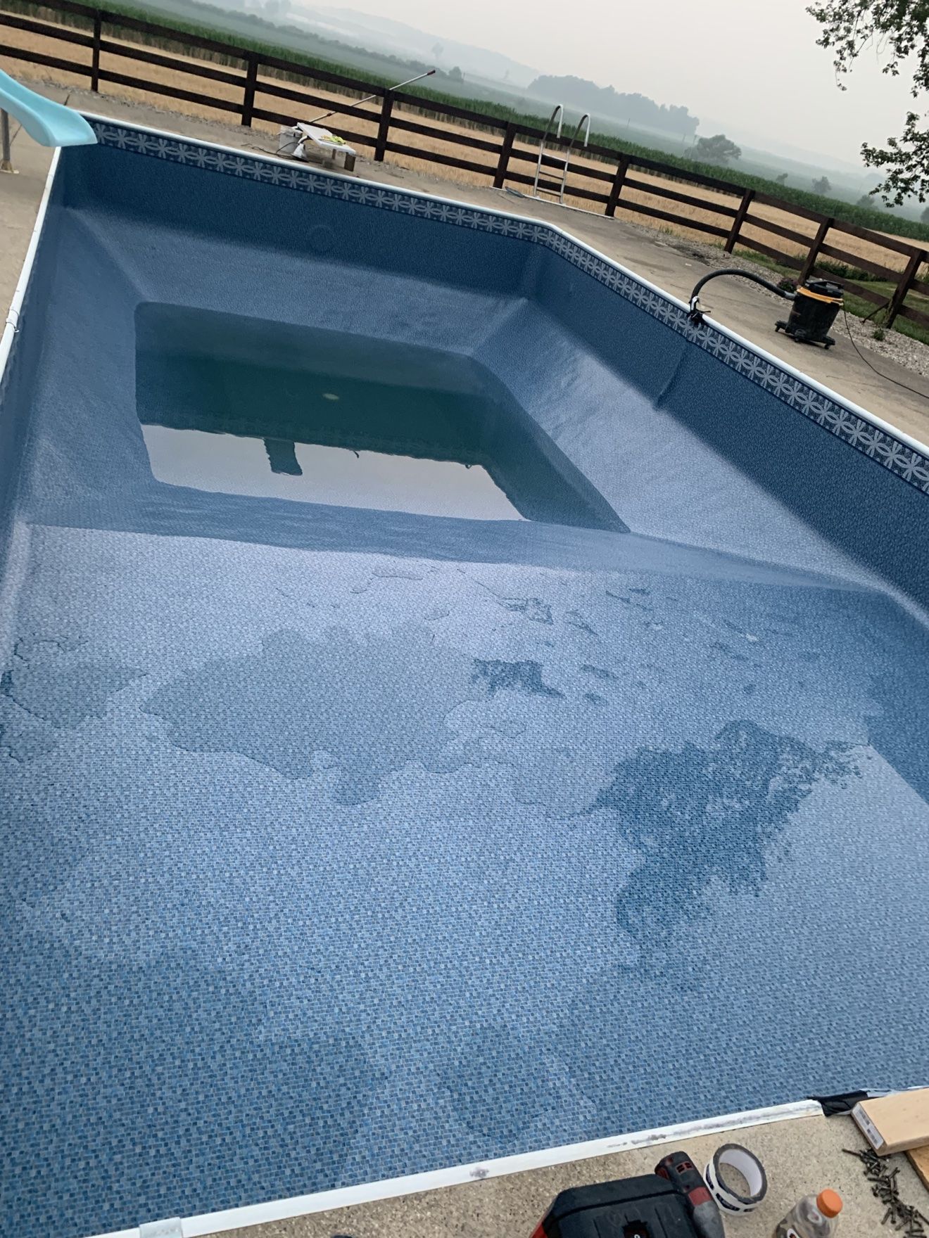 New vinyl liner being filled, water rising in the deep end of the pool