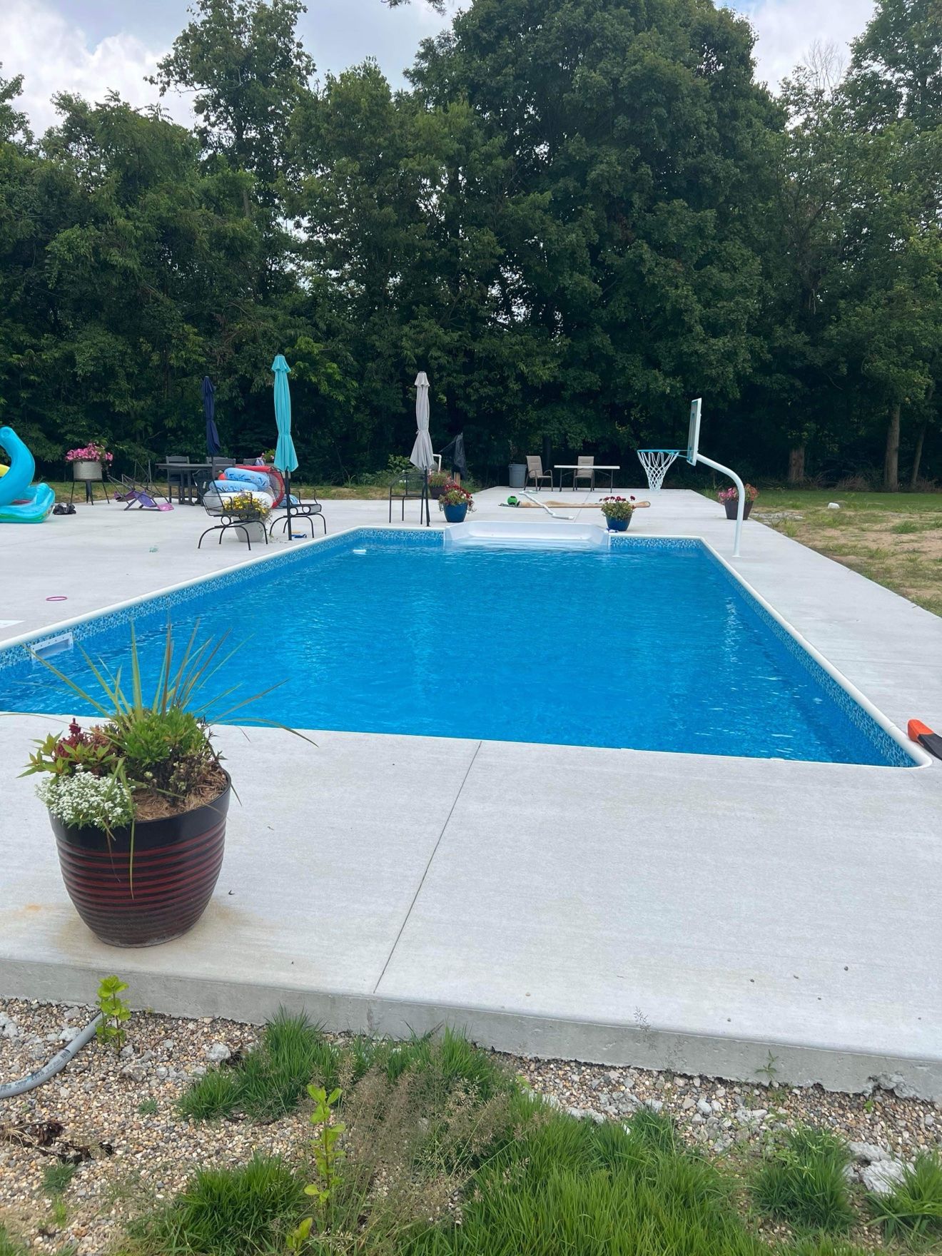 Same new inground build seen from the walk-in steps end of the pool